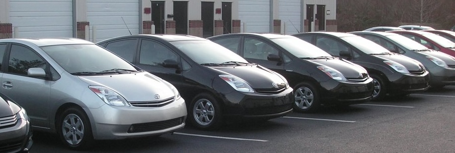 hybrid mechanics car parked in front of a building